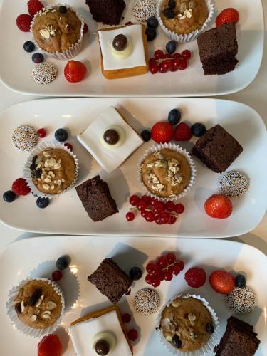 two plates of food with different types of desserts at De Heerlijkheid van Noordwelle Adults Only in Noordwelle