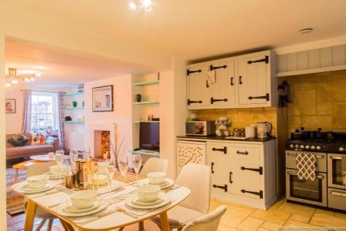 a kitchen with a table and chairs in a room at Seafront Apartment with Garden in Brighton & Hove