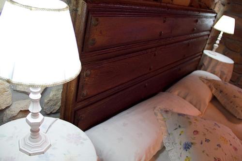 a bedroom with a bed with a table and a lamp at Casa Velarde in Torrelavega
