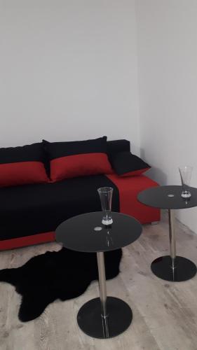 two tables in a living room with a couch at Apartament centrum Sienkiewicza WIEŻA EIFFLA PROMENADA -KLIMATYZACJA- WYJĄTKOWY in Kielce