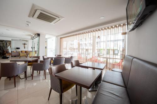 a restaurant with tables and chairs and a large window at Hotel Nossa Senhora da Paz in Fátima