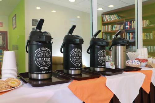 a group of three coffee makers on a table at Staybridge Suites Queretaro by IHG in Querétaro