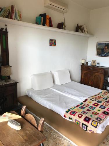 a bedroom with a bed with a quilt on it at hilltop villa garden with great views in Poggio Catino