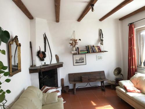 a living room with a couch and a fireplace at hilltop villa garden with great views in Poggio Catino