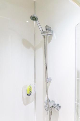 a shower with a shower head in a bathroom at Bedzzz - Booklovers Dream in Preston