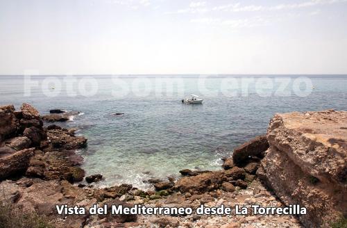 a boat in the water near a rocky shore at Acapulco playa Nerja 407 planta superior in Nerja