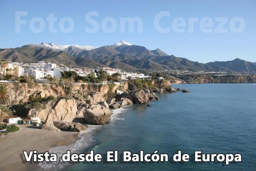 a view of a beach with a town and mountains at Acapulco playa Nerja 407 planta superior in Nerja