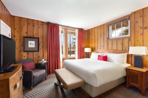 a hotel room with a bed and a television at Fairmont Jasper Park Lodge in Jasper
