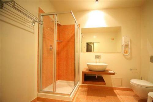 a bathroom with a shower and a sink and a toilet at Il Chiostro Del Carmine in Siena