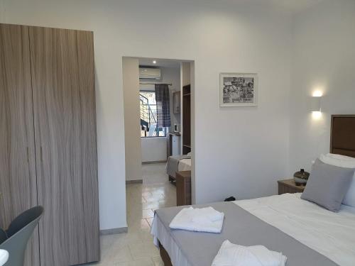 a bedroom with a bed with two towels on it at HARA BEACH in Rakhónion