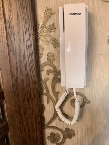 a white phone on the floor in a bathroom at Едем in Brzezhany