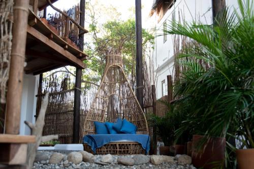 a patio with a swing and some plants at El Alquimista Yoga Spa in Zipolite