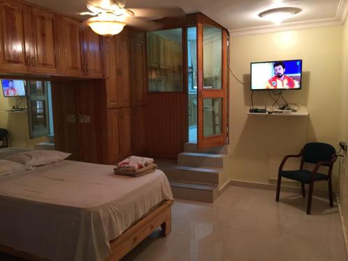 a bedroom with a bed and a flat screen tv at Terraza del Caribe in Boca Chica