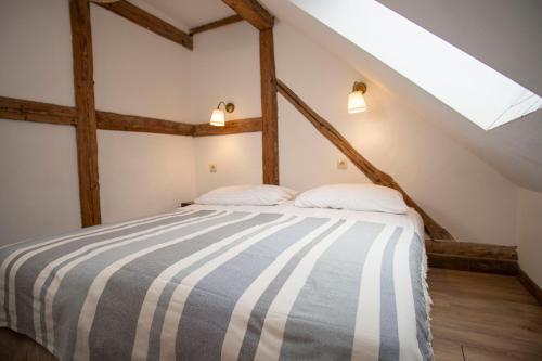 a bedroom with a bed in a attic at Dom pod Twierdzą Srebrna Góra in Srebrna Góra
