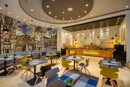 a restaurant with tables and chairs and a counter at ibis Quito in Quito