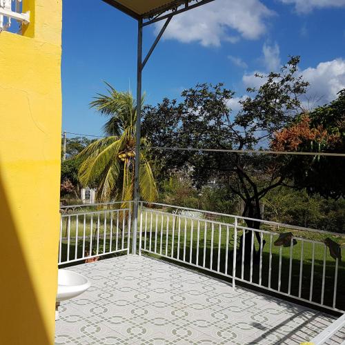 a balcony with a toilet and a fence at Villa Soleil DZ in Baillif