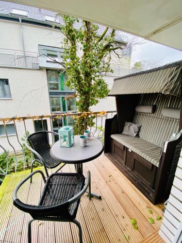 a patio with a table and chairs on a balcony at Ankerplatz Timmendorfer Strand in Timmendorfer Strand