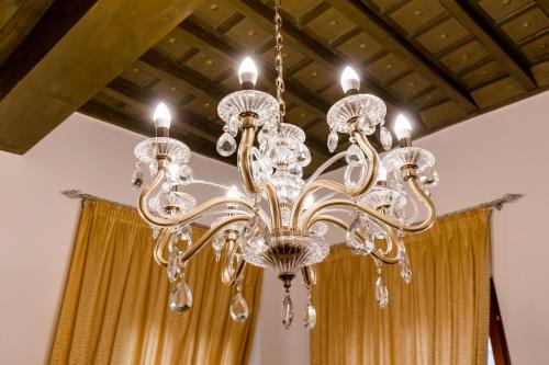a chandelier hanging from a ceiling with a curtain at Residenza Carlandi Tivoli in Tivoli