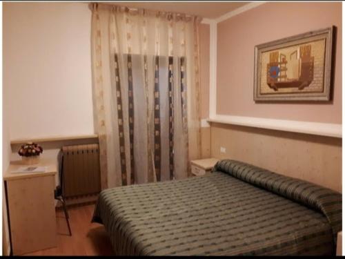 En eller flere senge i et værelse på Hotel ristorante Bucaneve