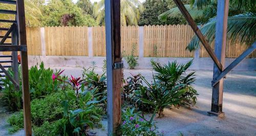 a garden with a fence and some plants at The Tranquila Caye- Gold Standard Certified in Caye Caulker