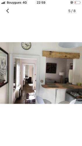 a kitchen and living room with a table and chairs at Maison cocooning avec petit jardin privatif in Limoges