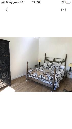 a bedroom with a bed and a dresser at Maison cocooning avec petit jardin privatif in Limoges