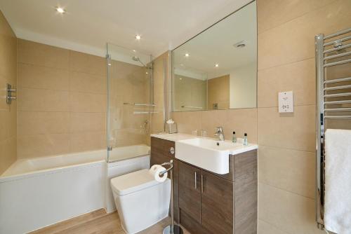 a bathroom with a sink and a toilet and a shower at Last Drop Village Hotel & Spa in Bolton