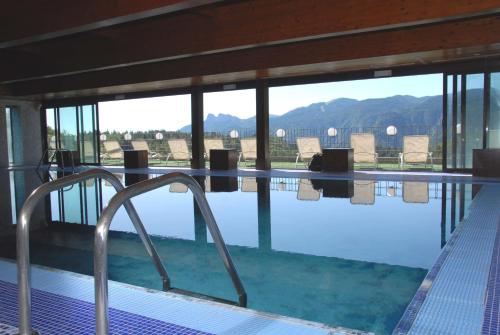 a swimming pool with a view of the mountains at Grand Hotel Astoria in Lavarone