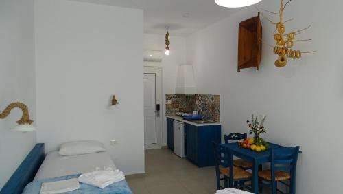 a small room with a bed and a small kitchen at Filoxenia Apartments & Studios in Theologos