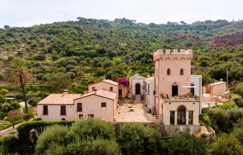 an old house with a tower on a hill at Villa Palamara 1868-Toweronthesea in SantʼAmbrogio