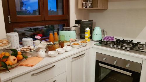 a kitchen counter with a bunch of food on it at B&B al civico16 in Guspini