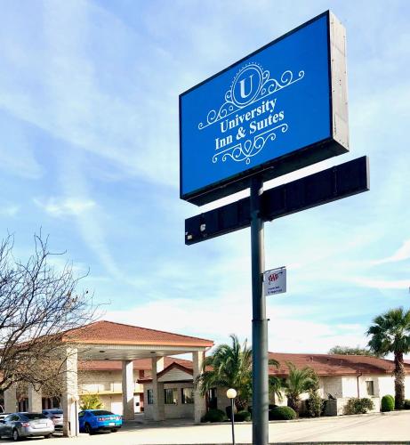 a sign on a pole in front of a store at University Inn & Suites in San Antonio