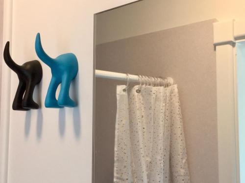 a mirror in a bathroom with a cat holder at Mitchella Eco Stay in Wanaka