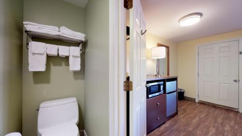 a bathroom with a toilet and a vanity with towels at Scarborough Beach Motel in Narragansett