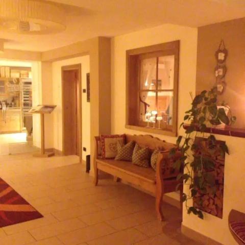 a living room with a couch and a window at Ciasa Alpina Relax Hotel in Moena