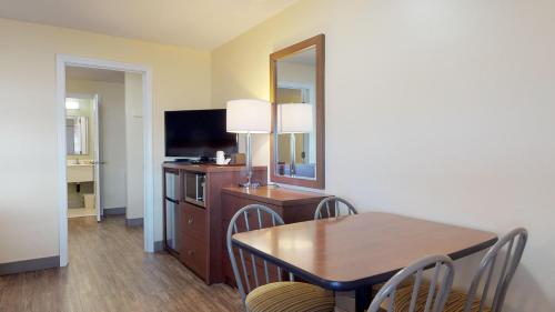 a dining room with a table and a mirror at Scarborough Beach Motel in Narragansett