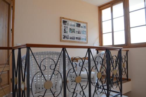 a balcony with a wrought iron railing and two windows at Kira's Boutique Hotel in Mindelo