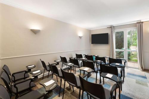 a room with a bunch of chairs and a screen at Best Western Plus Hyères Côte D'Azur in Hyères