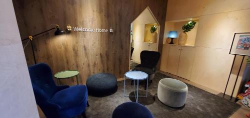 a waiting room with blue chairs and a table at Yomi Hotel - ShuangLian MRT in Taipei