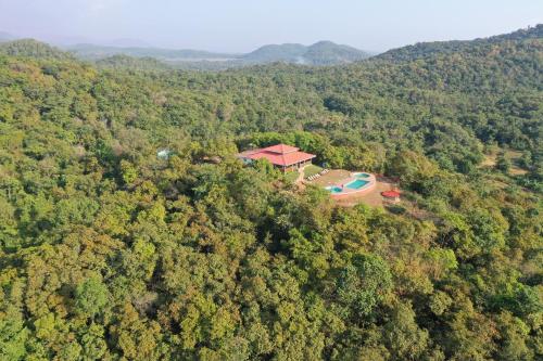 an aerial view of a house in the middle of a forest at Porsu in Canacona
