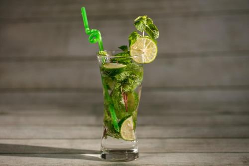 a vase filled with a drink with a lemon slice at Imperial Hotel & Spa in Hanoi