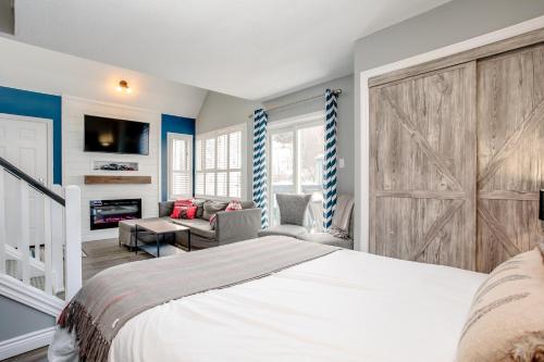 a bedroom with a large bed with a sliding barn door at Blue Mountain Studio Loft at North Creek Resort in Blue Mountains