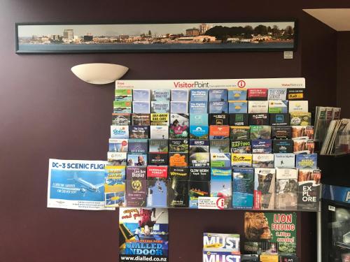 a bunch of books are on a wall at Harbour City Motor Inn & Conference in Tauranga
