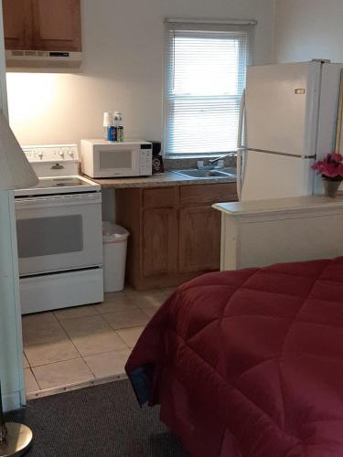 a kitchen with a white refrigerator and a stove at Clarysville Motel in Frostburg
