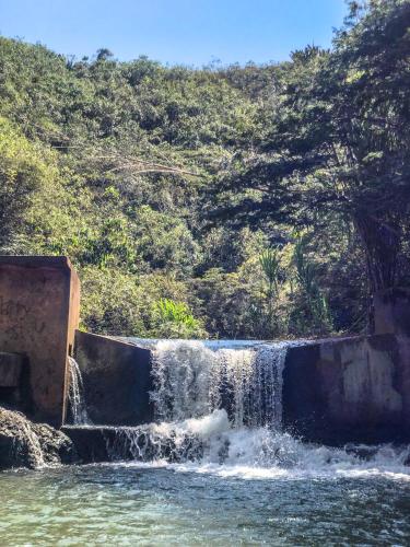 a waterfall in the middle of a body of water at Casa Campestre estilo Chalet Los Pirineos - Cerca a Cali in Cali