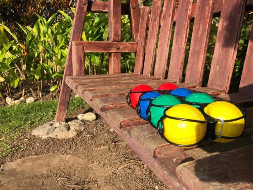 a bunch of colorful balls sitting on a wooden bench at Casa Campestre estilo Chalet Los Pirineos - Cerca a Cali in Cali