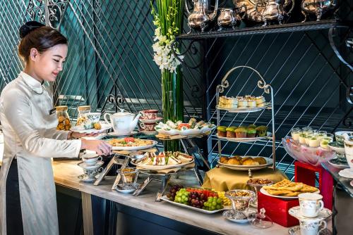 a woman standing in front of a buffet of food at Silverland Jolie Hotel in Ho Chi Minh City