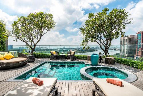 a swimming pool on top of a building at Silverland Jolie Hotel in Ho Chi Minh City