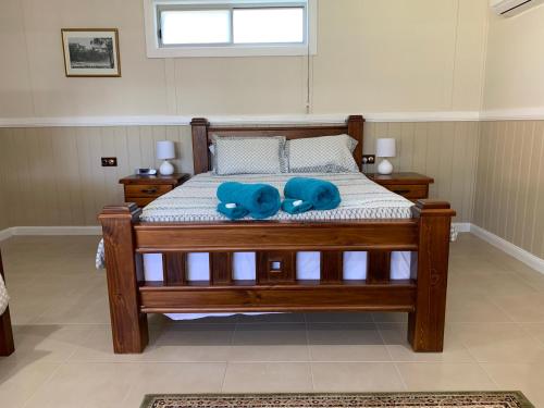 a bed with a blue stuffed animal on it at The Convent Boutique Accommodation in Hay