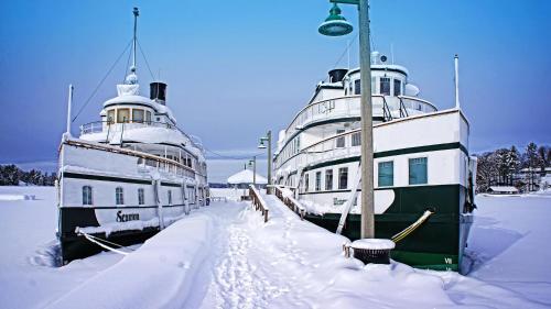 two boats are docked next to each other in the snow at Blue Spruce Bed and Breakfast Muskoka in Gravenhurst